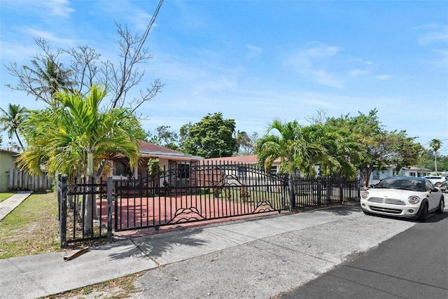 721 NW 6th St, Hallandale Beach, FL 33009 - view of gate featuring a fenced front yard
