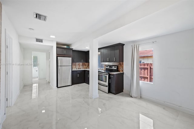 721 NW 6th St, Hallandale Beach, FL 33009 - kitchen with light countertops, visible vents, decorative backsplash, marble finish floor, and appliances with stainless steel finishes