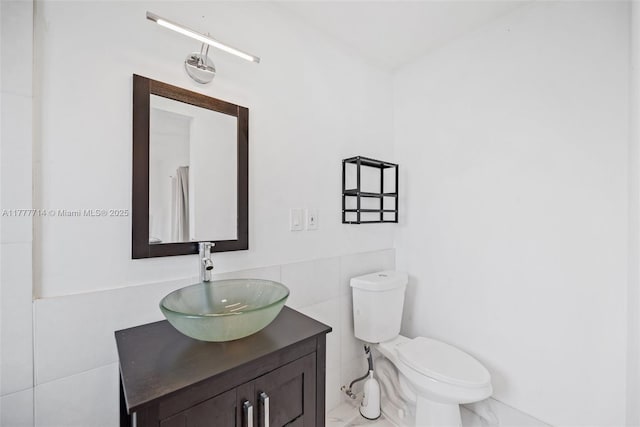 721 NW 6th St, Hallandale Beach, FL 33009 - bathroom with tile walls, toilet, marble finish floor, and vanity