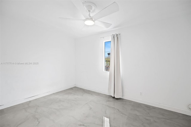 721 NW 6th St, Hallandale Beach, FL 33009 - spare room with baseboards, ceiling fan, and marble finish floor