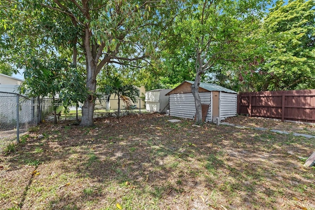 721 NW 6th St, Hallandale Beach, FL 33009 - view of yard featuring an outbuilding, a fenced backyard, and a shed