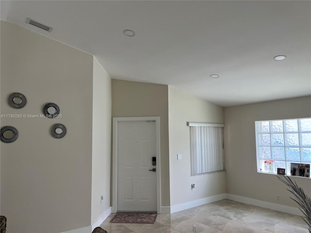 foyer with recessed lighting, visible vents, and baseboards