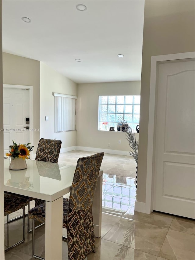 dining room featuring baseboards, recessed lighting, and marble finish floor