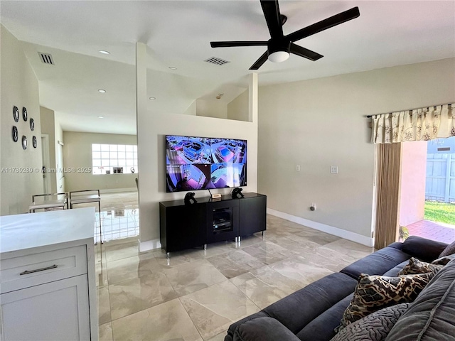 living room featuring baseboards, visible vents, a ceiling fan, and marble finish floor