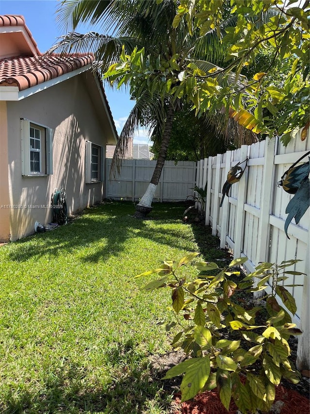 view of yard with a fenced backyard
