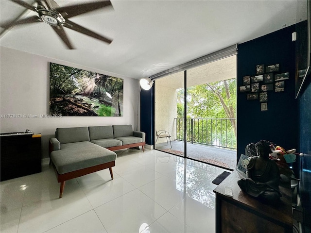 living area with a wall of windows, a ceiling fan, and tile patterned flooring