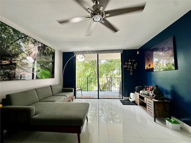 tiled living room featuring baseboards, a ceiling fan, and a wall of windows
