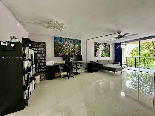 office space featuring tile patterned floors, ceiling fan, and expansive windows