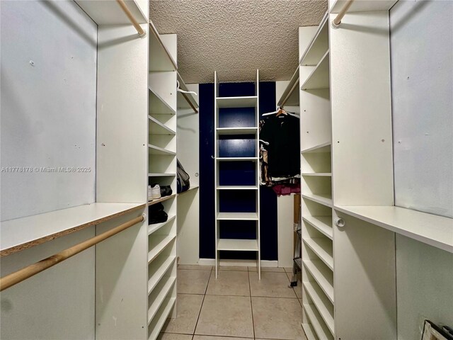 spacious closet featuring light tile patterned floors