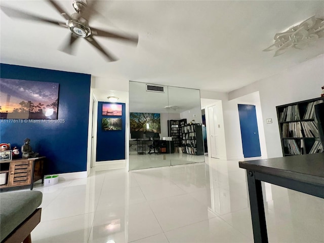 tiled living room featuring ceiling fan and visible vents