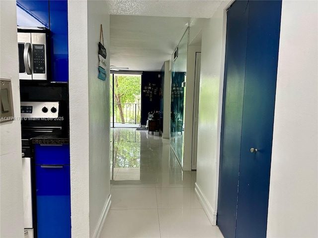 corridor with tile patterned floors and baseboards