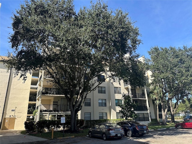 view of property featuring uncovered parking