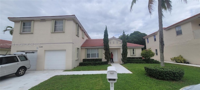mediterranean / spanish house featuring a garage, concrete driveway, a tile roof, stucco siding, and a front lawn
