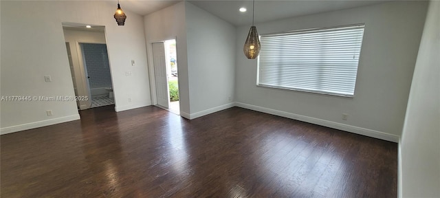 unfurnished room with dark wood-style flooring, baseboards, and recessed lighting
