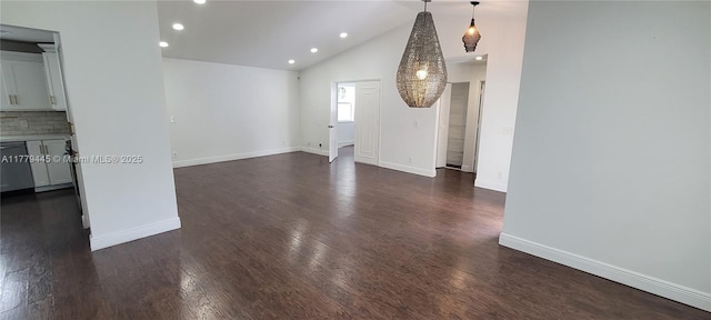 unfurnished living room with dark wood-type flooring, baseboards, recessed lighting, and vaulted ceiling