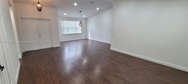 unfurnished room with dark wood-style flooring, baseboards, visible vents, and recessed lighting