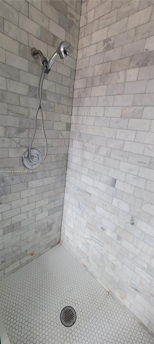 full bathroom with tiled shower