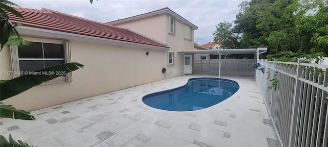view of swimming pool featuring a patio area, fence, and a fenced in pool