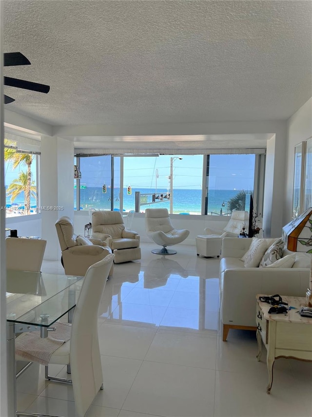 345 N Fort Lauderdale Beach Blvd Unit 202, Fort Lauderdale, FL 33304 - living area with a textured ceiling, a ceiling fan, and light tile patterned flooring