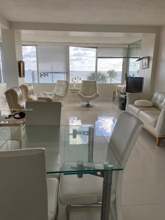345 N Fort Lauderdale Beach Blvd Unit 202, Fort Lauderdale, FL 33304 - dining space with tile patterned floors and a textured ceiling