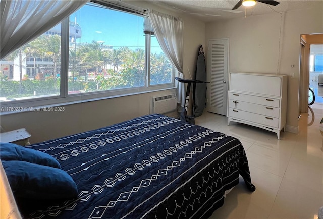 345 N Fort Lauderdale Beach Blvd Unit 202, Fort Lauderdale, FL 33304 - bedroom featuring ceiling fan, multiple windows, tile patterned flooring, and a wall mounted air conditioner