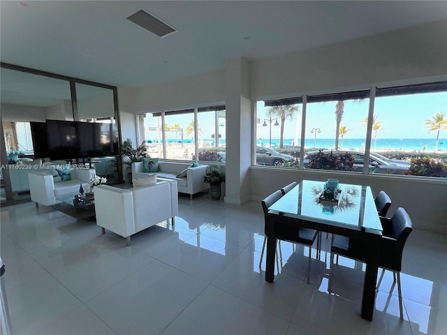 345 N Fort Lauderdale Beach Blvd Unit 202, Fort Lauderdale, FL 33304 - living area with a water view, visible vents, baseboards, and light tile patterned floors