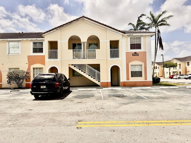 2524 SE 16th Rd Unit 201, Homestead, FL 33035 - view of building exterior featuring uncovered parking and stairs