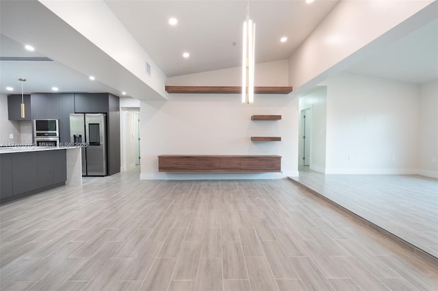 unfurnished living room with light wood-style floors, baseboards, visible vents, and recessed lighting
