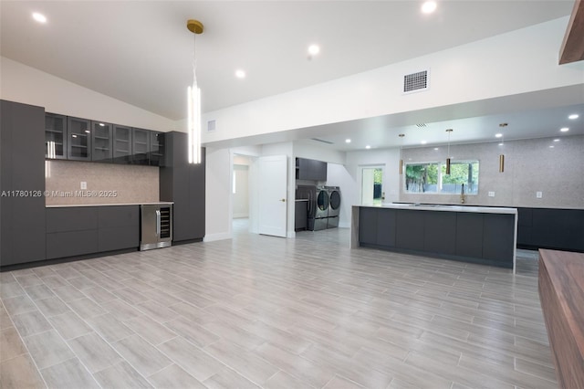 kitchen with separate washer and dryer, open floor plan, light countertops, visible vents, and modern cabinets