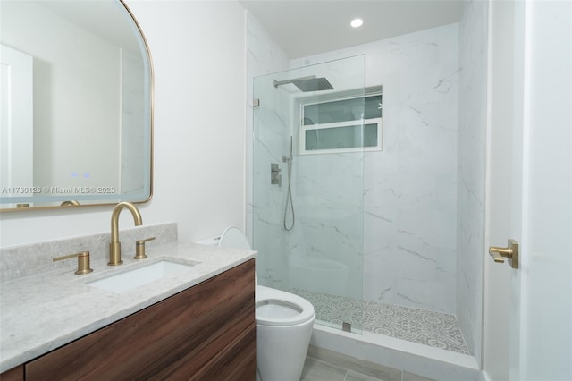 bathroom with recessed lighting, vanity, a marble finish shower, and toilet
