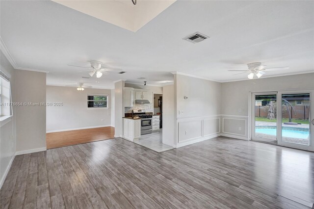 16395 SW 279th St, Homestead, FL 33031 - unfurnished living room with a ceiling fan, plenty of natural light, crown molding, and light wood-style flooring