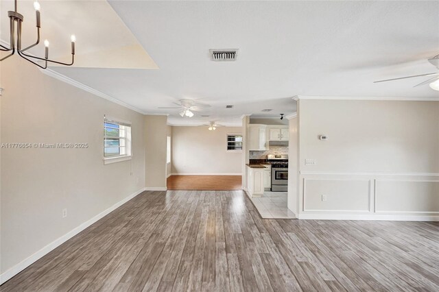 16395 SW 279th St, Homestead, FL 33031 - unfurnished living room with a ceiling fan, crown molding, light wood finished floors, and a chandelier