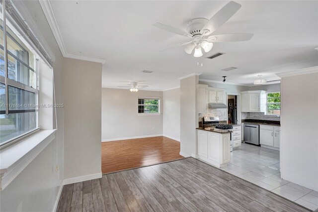 16395 SW 279th St, Homestead, FL 33031 - kitchen featuring ceiling fan, stainless steel appliances, dark countertops, crown molding, and decorative backsplash