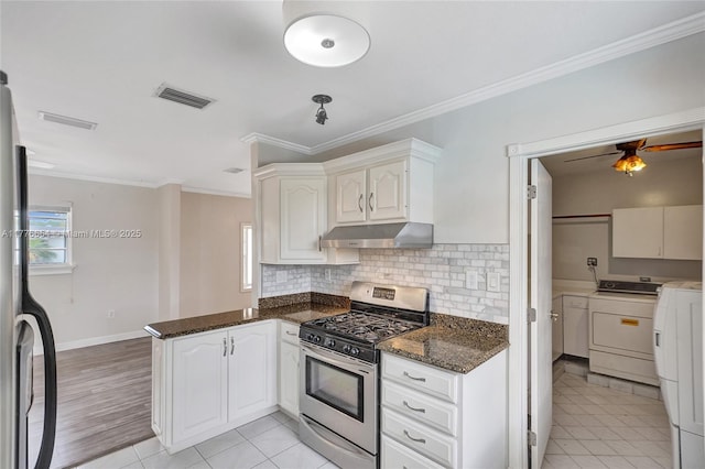 16395 SW 279th St, Homestead, FL 33031 - kitchen featuring stainless steel range with gas cooktop, under cabinet range hood, independent washer and dryer, a peninsula, and backsplash