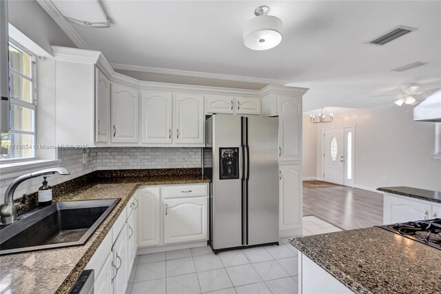 16395 SW 279th St, Homestead, FL 33031 - kitchen featuring stainless steel refrigerator with ice dispenser, a sink, white cabinets, decorative backsplash, and light tile patterned flooring