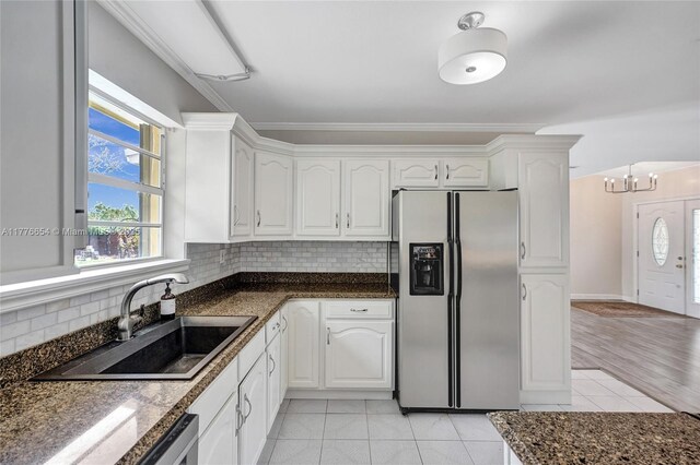 16395 SW 279th St, Homestead, FL 33031 - kitchen with stainless steel refrigerator with ice dispenser, light tile patterned floors, a sink, white cabinetry, and crown molding