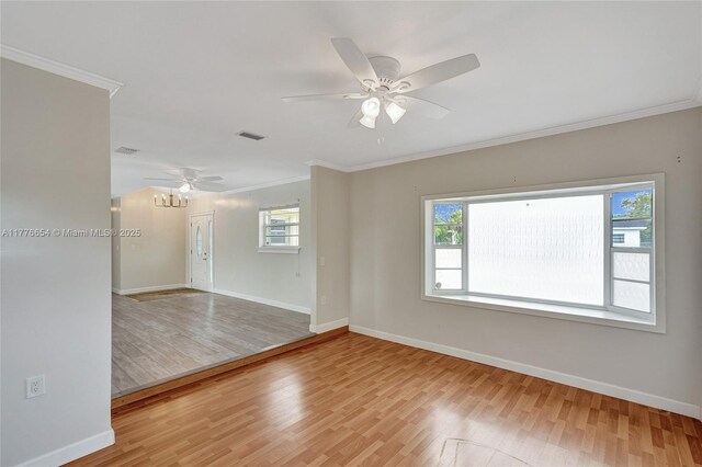 16395 SW 279th St, Homestead, FL 33031 - empty room with light wood finished floors, healthy amount of natural light, crown molding, and baseboards