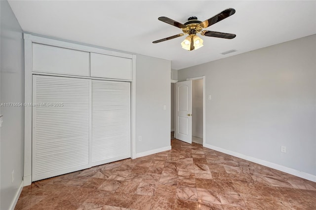 16395 SW 279th St, Homestead, FL 33031 - unfurnished bedroom with a closet, baseboards, marble look tile flooring, and a ceiling fan