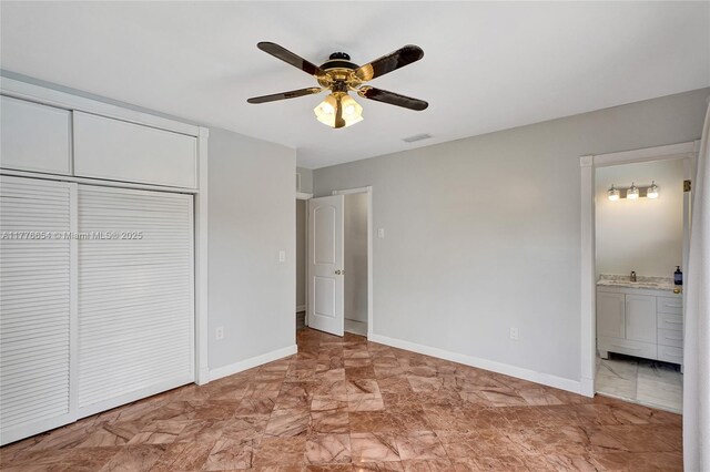 16395 SW 279th St, Homestead, FL 33031 - unfurnished bedroom featuring a closet, light marble finish flooring, baseboards, and a sink