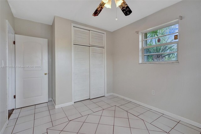 16395 SW 279th St, Homestead, FL 33031 - unfurnished bedroom featuring a closet, baseboards, a ceiling fan, and light tile patterned floors