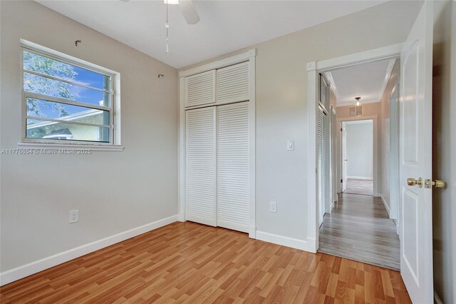16395 SW 279th St, Homestead, FL 33031 - unfurnished bedroom with light wood-type flooring, baseboards, attic access, and a ceiling fan