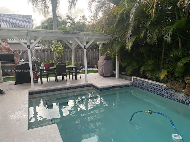 view of swimming pool with a pergola, a patio area, a fenced in pool, grilling area, and fence