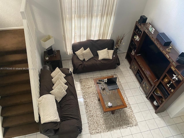 living room with light tile patterned flooring and stairway
