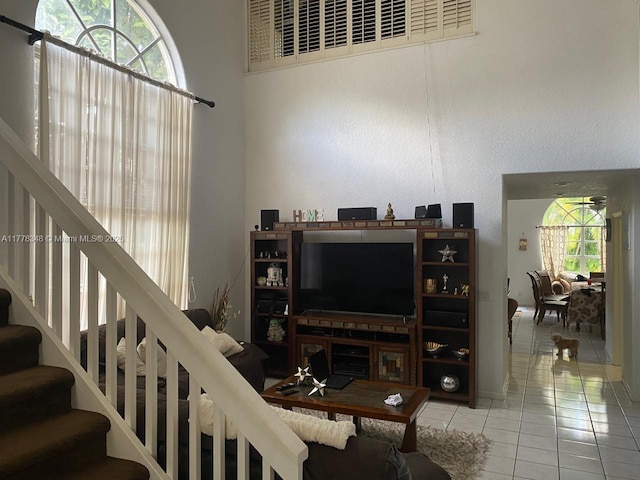 tiled living room featuring stairway