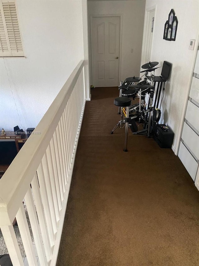 hall with visible vents and carpet flooring