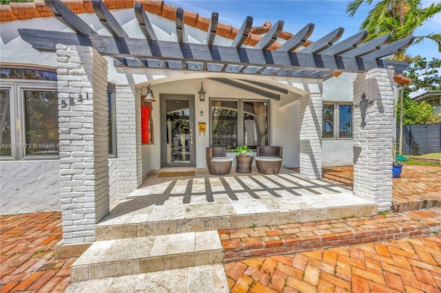 doorway to property with a pergola