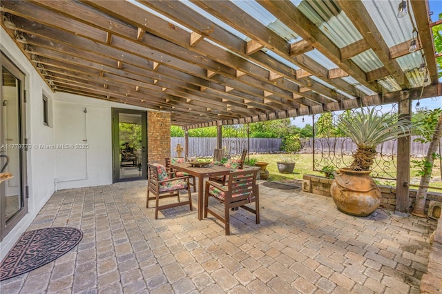 view of patio featuring outdoor dining space, a pergola, and a fenced backyard