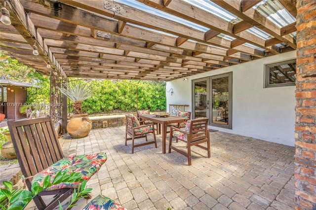 view of patio featuring a pergola, outdoor dining space, and french doors