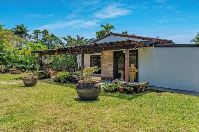 rear view of property featuring a lawn and a pergola