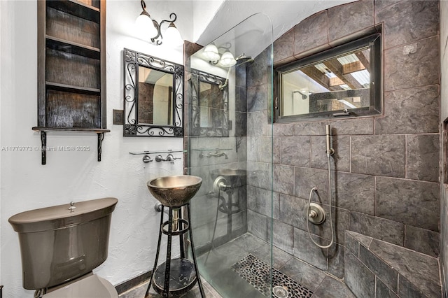 bathroom with tiled shower and toilet